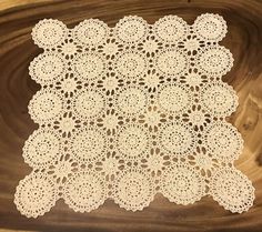 a white doily on top of a wooden table