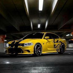 a yellow dodge charger parked in a parking garage