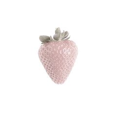 a pink strawberry sitting on top of a white table