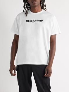 As much as we love Burberry for its more complex designs, the brand always nails the basics. This T-shirt is cut from white cotton-jersey in a relaxed fit and printed with the house's logo in contrasting black. Luxury Short Sleeve T-shirt With Logo Lettering, Burberry Replica Shirt, Luxury White T-shirt With Logo Print, Luxury Monogram Print T-shirt For Men, Burberry Inspierd Shirt, Burberry Logo, Latest T Shirt, Burberry Men, Home Logo