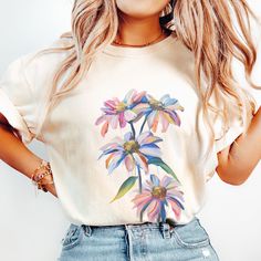 🌸 Embrace Nature's Beauty with our Wildflower Shirt! 🦋 Calling all flower enthusiasts and garden lovers! Elevate your wardrobe with our stunning Flower shirt, featuring delicate wildflowers. It's not just a shirt; it's a celebration of nature's wonders. Crafted with the utmost care, our Flower shirt is a testament to both style and comfort. Made from 100% ring-spun cotton, this Comfort Colors garment-dyed t-shirt offers unparalleled softness and durability. The medium-weight fabric ensures yea Wildflower Shirt, Watercolor Wildflowers, Gift For Gardener, Embrace Nature, Outfit Christmas, Floral Outfit, Garden Lovers, Flower Shirt, Flower Lover