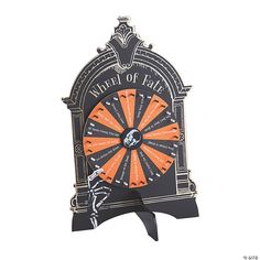 an orange and black clock with the words master of fate on it's face