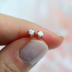 "These dainty opal studs will be your new favorite. They have just the right amount of sparkle and are perfect for a girl who wants something subtle.  ✩\"Single\" means \"one earring\", \"Full pair\" means \"two earrings\" ✩ Made of solid sterling silver ✩ Made to last. Allergy-free. Good for sensitive skin.  ✩ Posts come with a pair of butterfly and clear rubber backs. ✩ 3 mm opal ✩ Ship beautifully packaged More blings from Joylene: https://www.etsy.com/shop/joylenedesign We only choose the finest diamond simulants (CZ 6A) on the market, with a breathtaking level of brightness like real diamonds. Our jewelry can be found in stores and boutiques in Illinois, Indiana and Wisconsin. We always believe that if we invested all of our love and passion into every piece we make, our customers wil Dainty Opal Earrings For Gift, Dainty Hypoallergenic Opal Earrings, Minimalist Hypoallergenic Opal Earrings, Minimalist Opal Earrings, Minimalist Opal Earrings For Gift, Minimalist Opal Earrings As Gift, White Opal Stud Earrings, Opal Stud Earrings, Manual Work