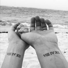 two people holding hands with roman numerals on their wrist and the words get a matching tattoo with my boyfriend