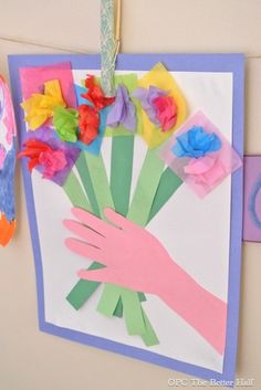 a hand holding flowers made out of paper on a bulletin board with the words 10 diy craft ideas to make your kid