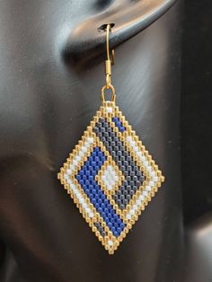 a close up of a pair of earrings on a mannequin's head