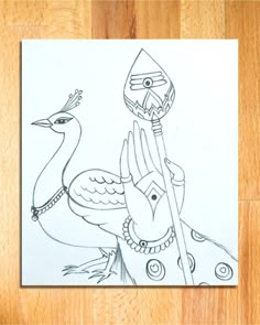 a drawing of a bird holding a spear on top of a wooden floor next to a piece of paper