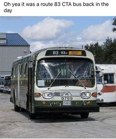 there is a bus that is parked in the parking lot next to other buses and cars