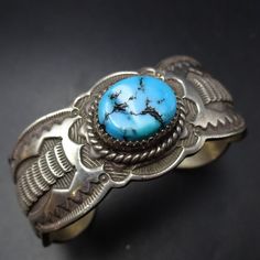 SIGNED VINTAGE NAVAJO BLUE KINGMAN TURQUOISE BRACELET DESCRIPTION:  With an abundance of hand-applied stamp work and a gorgeous specimen of natural blue Kingman turquoise, this bracelet will be a cherished addition to your collection of fine vintage Southwestern and Native American jewelry. MEASUREMENTS: Interior of the cuff measures 5 1/2" with an additional 1" slightly adjustable gap. Total circumference:  6 1/2" Measures 2 1/4" straight across the widest part  (from wrist bone to wrist bone) Classic Handmade Turquoise Bracelets, Blue Stamped Bracelet As Gift, Artisan Blue Stamped Bracelets, Artisan Blue Engraved Cuff Bracelet, Artisan Engraved Blue Bracelets, Artisan Blue Bracelets Collectible, Southwestern Engraved Blue Cuff Bracelet, Bohemian Stamped Blue Bracelets, Blue Stamped Bohemian Bracelets