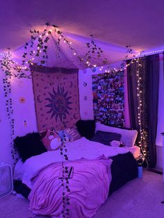 a bedroom with purple lights and decorations on the walls