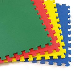 four different colored foam mats laid out on top of each other