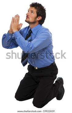 a man kneeling on the ground with his hands together and praying in front of him