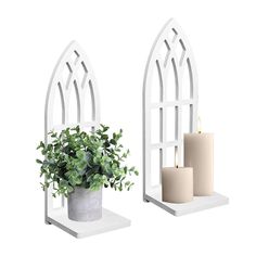 two white candle holders with plants in them and one holding a potted plant next to it