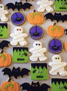 halloween decorated cookies are arranged on a table