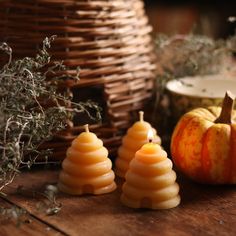 three candles sitting on top of a wooden table