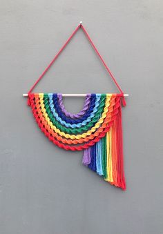 a multicolored wall hanging on a gray wall