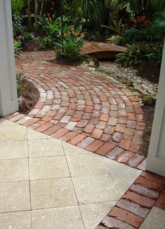 an open door leading to a brick walkway