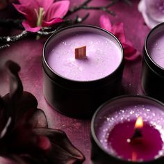 three purple candles sitting on top of a table