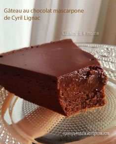 a piece of chocolate cake sitting on top of a glass plate