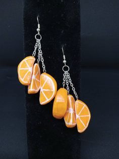 three orange slices hanging from chain earrings