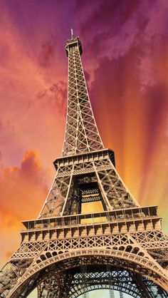 the eiffel tower in paris, france is lit up at sunset with pink clouds