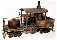 an old wooden train cart with barrels on the wheels