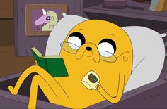 a cartoon character laying in bed reading a book