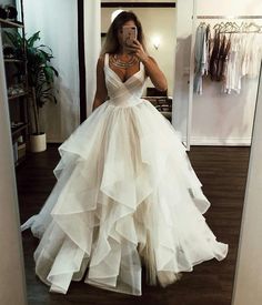 a woman is taking a selfie in her wedding dress while looking into the mirror