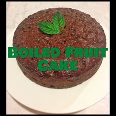 a chocolate cake on a white plate with the words boiled fruit cake