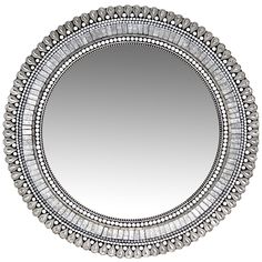 a round mirror with beading around the edges