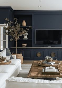 a living room filled with furniture and a flat screen tv mounted on a wall above a wooden coffee table