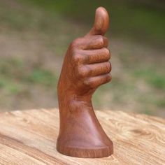 a wooden hand with a thumbs up sign