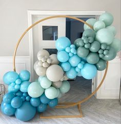 a bunch of balloons that are in the shape of a circle on a stand near a door