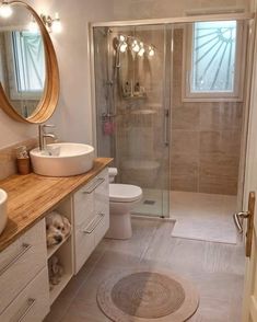 a bathroom with a sink, toilet and shower stall is pictured in this image from the inside