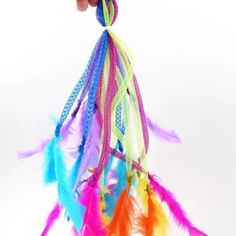 a hand holding a multicolored dream catcher