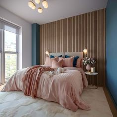 a bedroom with blue walls and pink bedding