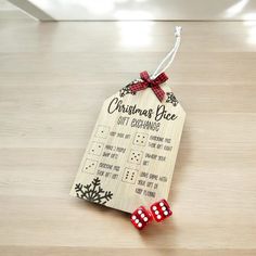 a wooden christmas price tag with two red dices