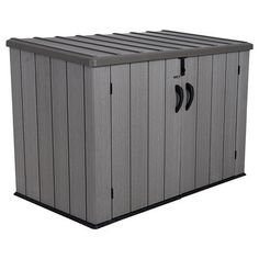 an outdoor storage shed with the door open and two wheels on it's side