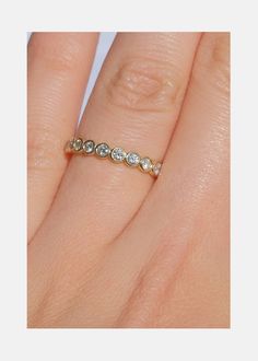 a woman's hand with a diamond ring on it