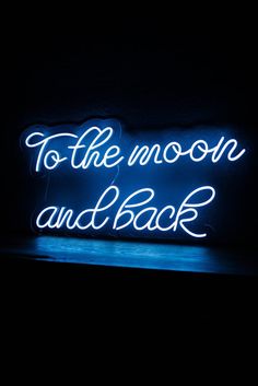 a neon sign that says to the moon and back