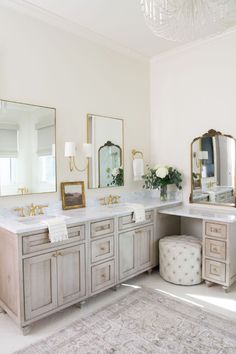 a large bathroom with two sinks and mirrors