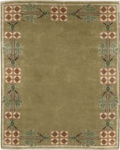 a green rug with an ornate border on the top and bottom, in different colors