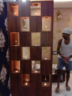 a man standing in front of a wooden display case