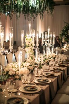 a long table is set up with candles and flowers for an elegant dinnereon party