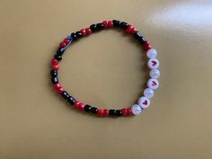 Inspired by everyone's favorite insect, ladybugs and by the TV show, Miraculous Ladybug, this is a red and black seeded bracelet combined with heart beads and pearls. Casual Handmade Heart Bracelet With Round Beads, Casual Black Heart-shaped Bracelets, Casual Black Heart-shaped Bracelet, Red Beaded Heart Bracelet With Round Beads, Casual Black Beaded Bracelets For Valentine's Day, Casual Black Bracelets For Valentine's Day, Red Beaded Heart Bracelet As Gift, Gift Red Beaded Heart Bracelet, Casual Red Beaded Bracelets With Black Beads