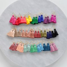 "Just the pop of color you need. These hand-tied tassel earrings are made with cotton threads so they're virtually weightless. So lightweight, you might just forget you have them on. That is until you start hearing \"I love your earrings!\" again and again! The only problem is the 25 different colors. How will you ever choose? ;) + super lightweight cotton tassel in a choice of 25 different colors + gold-plated OR silver-plated stainless steel ear wire hooks (lead-free and nickel-free) + comes w Girls Trip Gifts, Plastic Earrings, Earring Cards, Bohemian Earrings, Bijoux Diy, Diy Earrings, Earring Backs, Tassel Earrings, Ear Wire