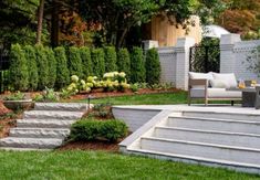 an outdoor living area with stairs and landscaping