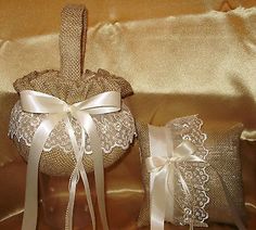 two wedding garters are sitting on a gold satin material sheet with white ribbons