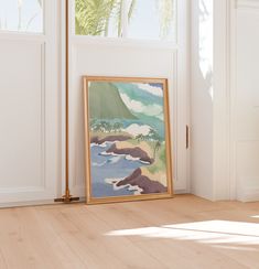 a painting is sitting on the floor in front of a door with an open window