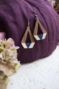 Crafted from sustainably sourced wood, these geometric earrings are the perfect partner to this season’s Art-Deco inspired prints. This modern drop design is lightweight, making these earrings easy for everyday wear – or add a modern touch to an evening outfit.  Handcrafted by The Daughters of the Ganges, a fair trade organisation who partner with artisan communities in India.  #ethicaljewellery #woodjewellery #ecojewellery #ethicalstyle #sustainablestyle Nomad Clothing, Eco Jewelry, Evening Outfit, Drop Design, Perfect Partner, Natural Colours, Evening Outfits